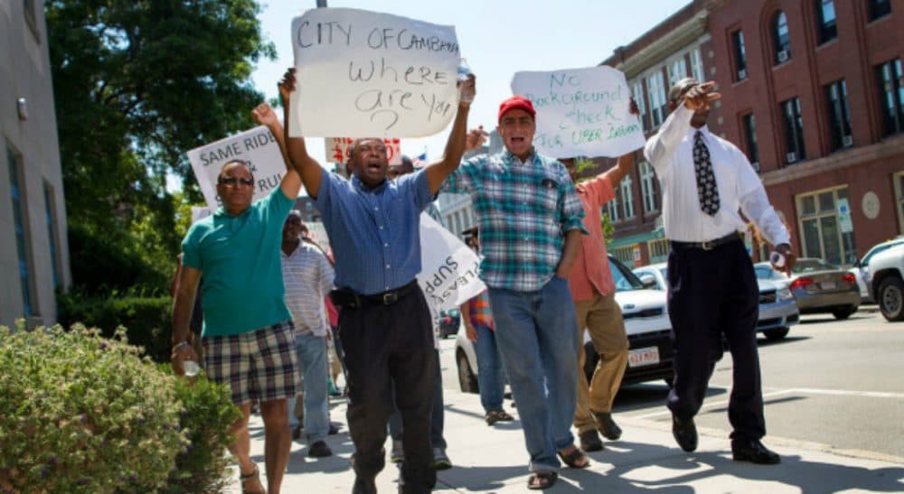 Tom LeCompte: &quot;The 'one-day' strike in front of City Hall barely lasted a half-day, breaking up in time for drivers to catch the rush hour business to Logan or the hotels.&quot; Pictured: Cambridge taxi drivers protest on the street outside City Hall Monday, August 3, 2015. (Hadley Green/WBUR)