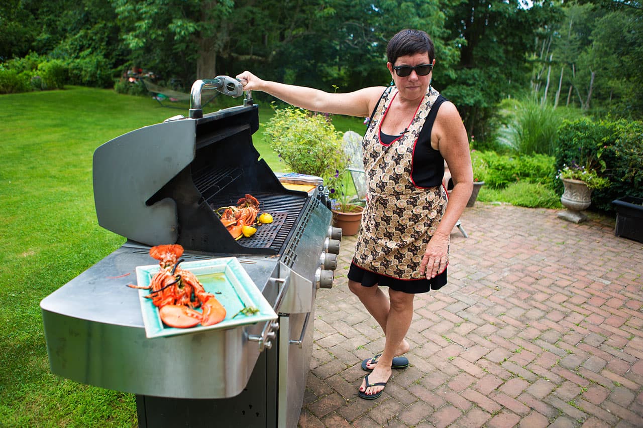 Kathy Gunst grills lobsters in her backyard in Maine. (Jesse Costa/WBUR)