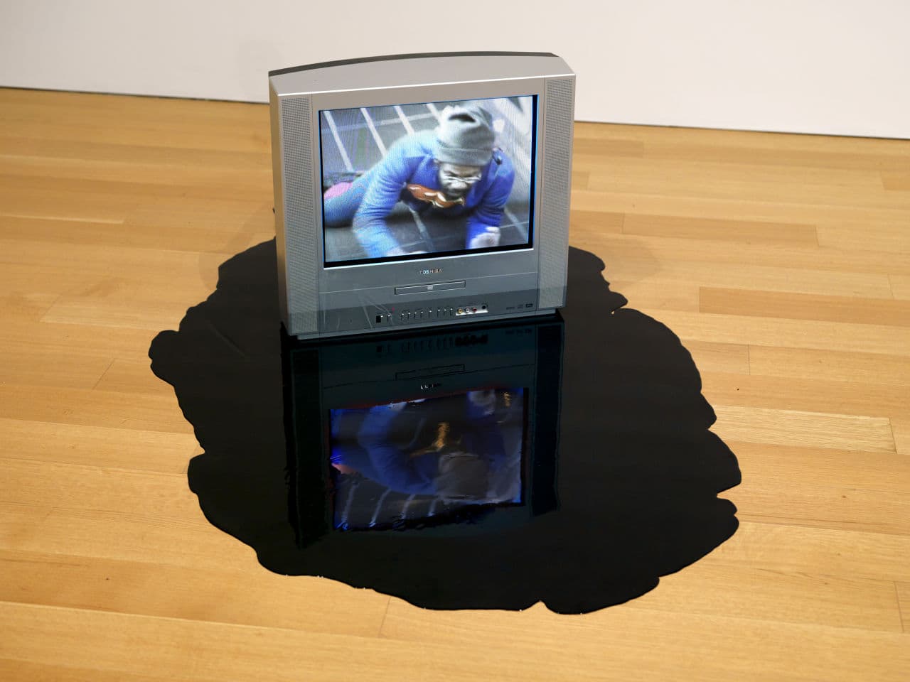In an exhibit at the deCordova, artist William Pope L. is seen inside a television showing him crawling the 22 miles of New York's Broadway in his project called "The Great White Way." (Courtesy of the artist and Mitchell-Innes & Nash; Photo by Clements Photography and Design in Boston)