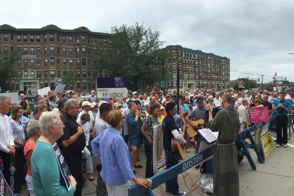 Approximately 300 people protested in front of the Planned Parenthood in Allston on Saturday. (Simón Rios/WBUR)