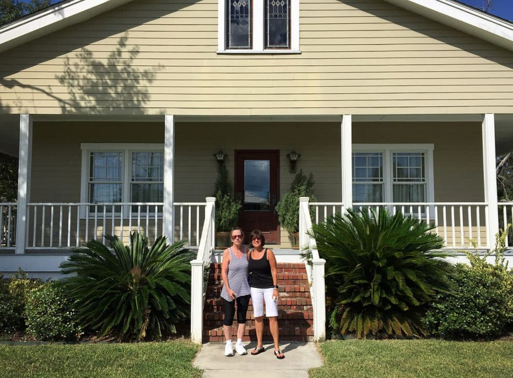 Melanie Karetas, left, of Waveland, Mississippi, and Cindy Lombardo of Wayland, Massachusetts, pose in front of Karetas' Waveland home on Saturday. The group Wayland to Waveland built the home after Hurricane Katrina, and the two have remained friends since. (Courtesy of Cindy Lombardo)