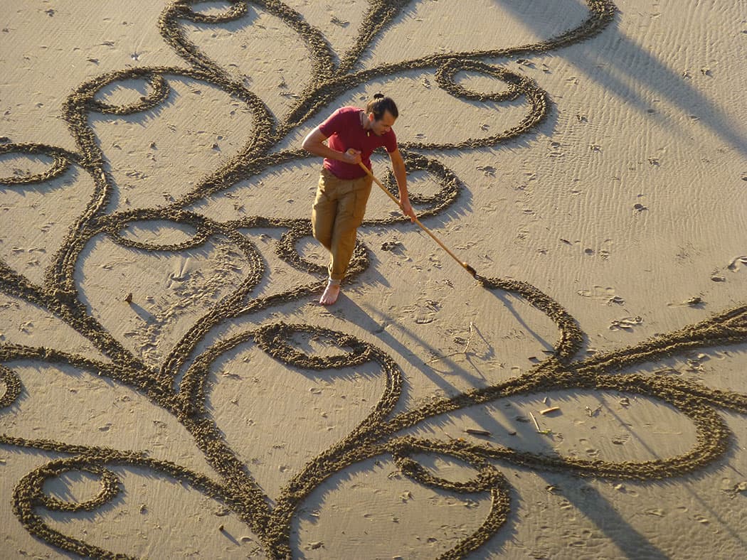 Andres Amador raking sand to create his designs. (Michelle Ranson)