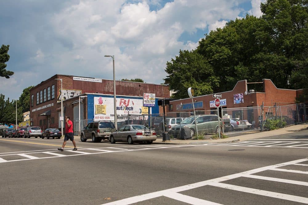 The corner of Washington and Montebello streets in Jamaica Plain is seen last month. A 76-unit development at 3200 Washington St. will replace E&J Auto Tech and an abandoned building. (Jesse Costa/WBUR)