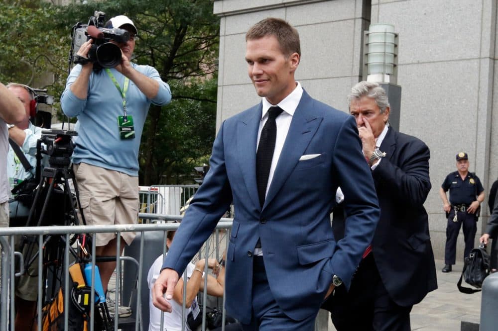 Patriots QB Tom Brady can suit up for his team’s season opener after a judge erased his four-game suspension for “Deflategate.” Here he is leaving federal court after a hearing on Monday. (Richard Drew/AP)
