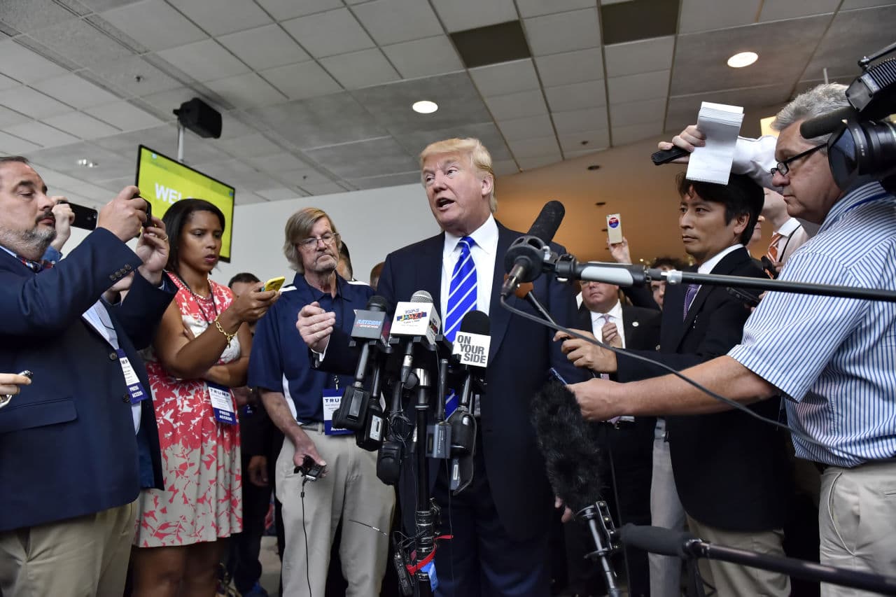 Republican presidential candidate Donald Trump answers questions from the media after speaking during a rally at the TD Convention Center on Thursday. (Richard Shiro/AP)