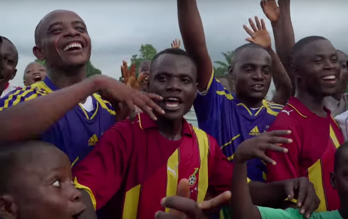 Erison (far right) and his teammates lost to a team of Ebola aid workers, but all were smiling after the game. ("Erison And The Ebola Soccer Survivors")