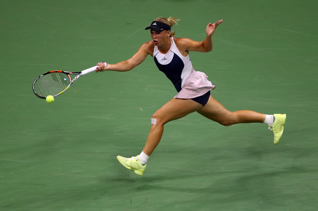 Caroline Wozniacki extends for a forehand but falls short in a rare second round exit. (Clive Brunskill/Getty Images)
