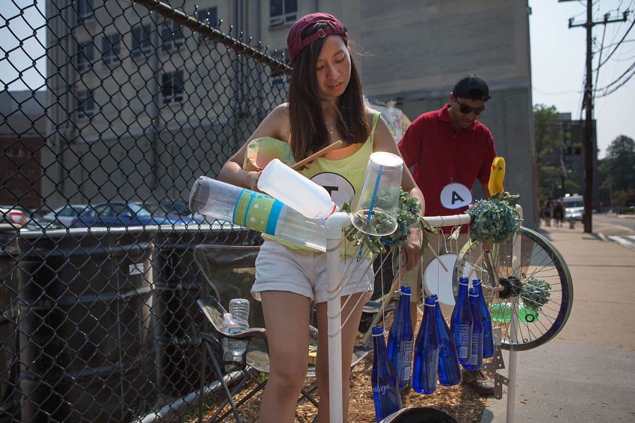 Tammy Shen plays her instrument made of bottles and plastic containers. (Jesse Costa/WBUR)