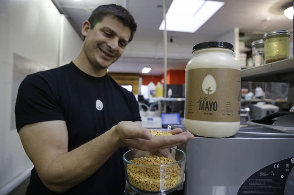 Hampton Creek Foods CEO Josh Tetrick holds a species of yellow pea used to make Just Mayo, a plant-based mayonnaise, in San Francisco, Dec. 3, 2013. (Eric Risberg/AP)