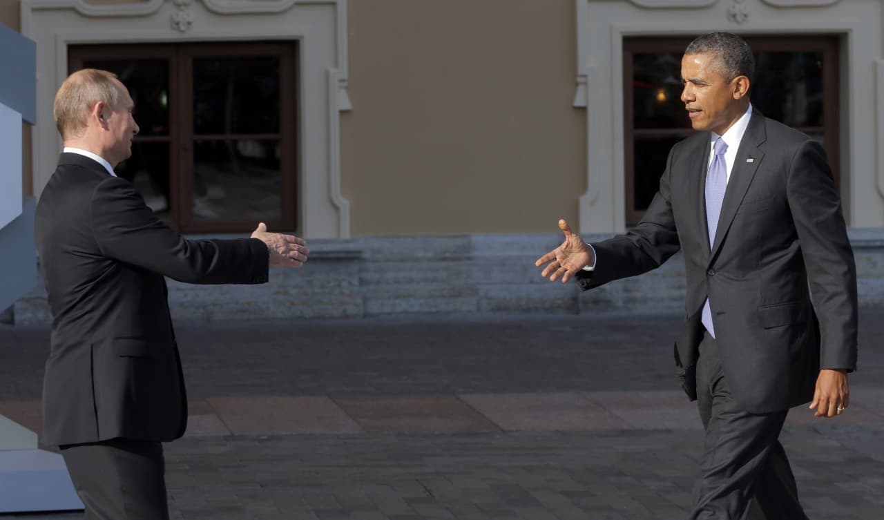 Russia's President Vladimir Putin and U.S. President Barack Obama will hold their first face-to-face meeting today in nearly a year. In this Sept. 5, 2013, photo, Putin reaches out to shake hands with Obama during arrivals for the G-20 summit at the Konstantin Palace in St. Petersburg, Russia. (Dmitry Lovetsky/AP)