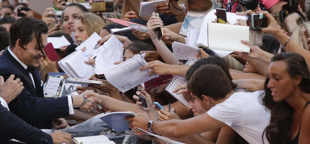Actor Johnny Depp signs autographs for his fans as he arrives for the screening of the movie "Black Mass" at the 72nd edition of the Venice Film Festival in Venice, Italy, Friday. (Andrew Medichini/AP)