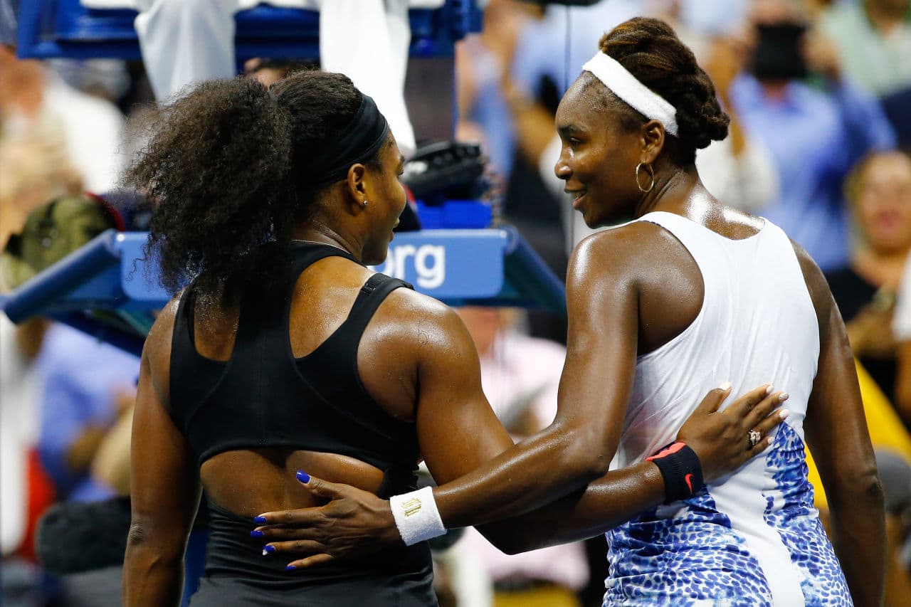 Venus and Serena Williams embrace after Serena defeats her sister to advance to the semi-finals. (Al Bello/Getty Images)