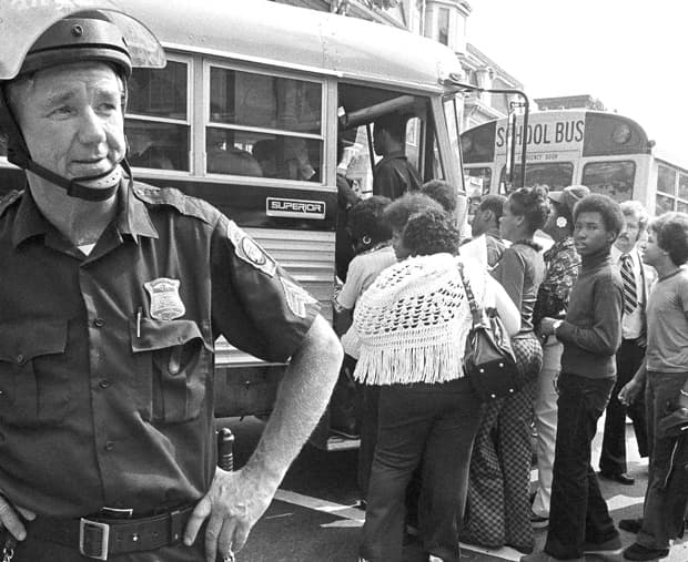 African-American students board a school bus outside South Boston High School on Sept. 12, 1974 — the first day of school and the first day of court-ordered busing. (AP)