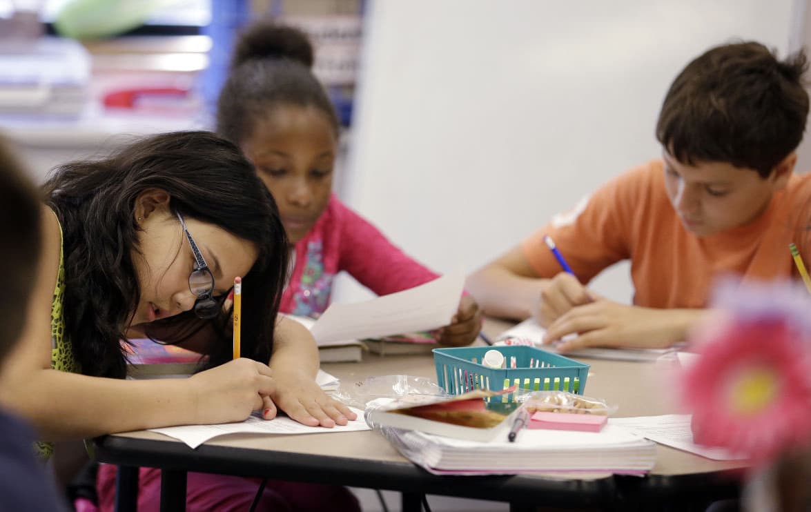 Fifth graders write during class at John Hay Elementary school in Seattle, Oct. 2, 2014. (Elaine Thompson/AP)