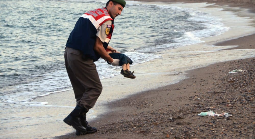 A Turkish paramilitary police officer carries the body of 3-year-old Aylan Kurdi, found washed ashore near the Turkish resort of Bodrum early Wednesday, Sept. 2, 2015. The boats carrying the boy's family to the Greek island of Kos capsized. His 5-year-old brother and mother also lost their lives. (AP)