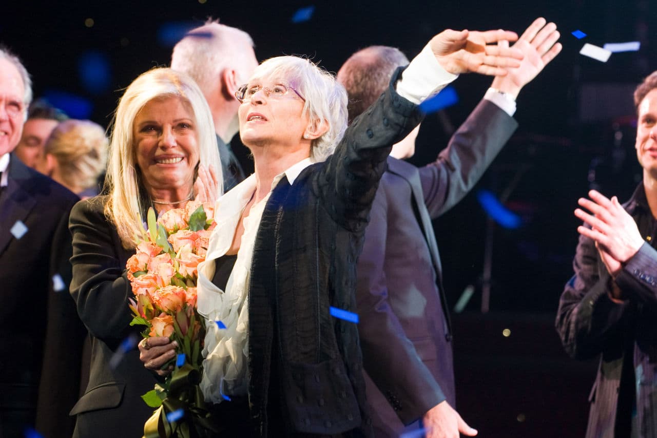 Renown choreographer Twyla Tharp throws her hand up at the curtain call for the opening night of Broadway's "Come Fly Away" in 2010. (Charles Sykes/AP)