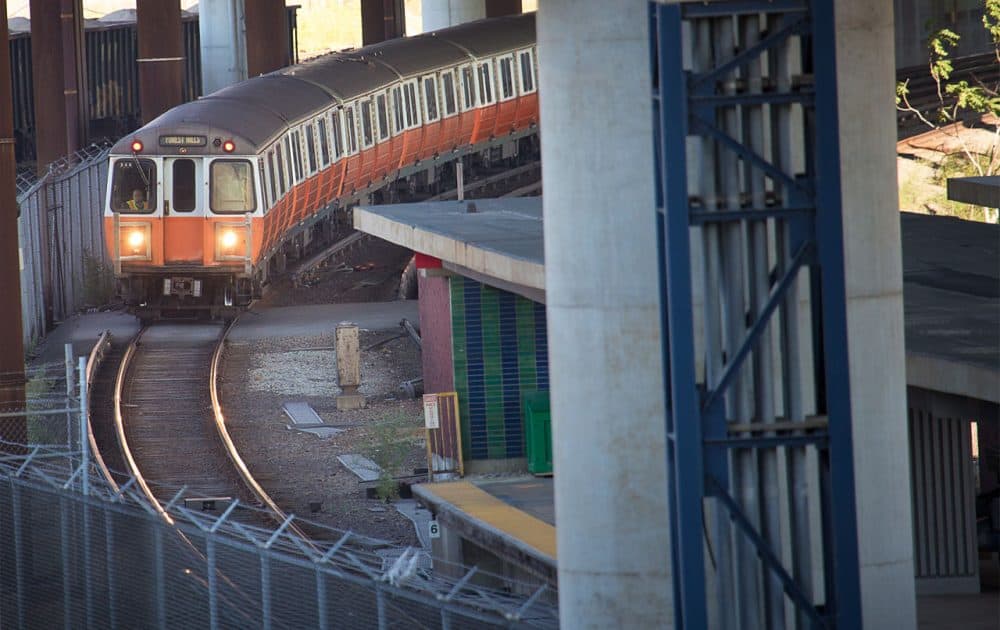 An Orange Line train pulls into Community College Station in Charlestown. The MBTA's operating expenses and debt service, a new report says, are growing at nearly three times the rate of revenue growth. (Jesse Costa/WBUR)