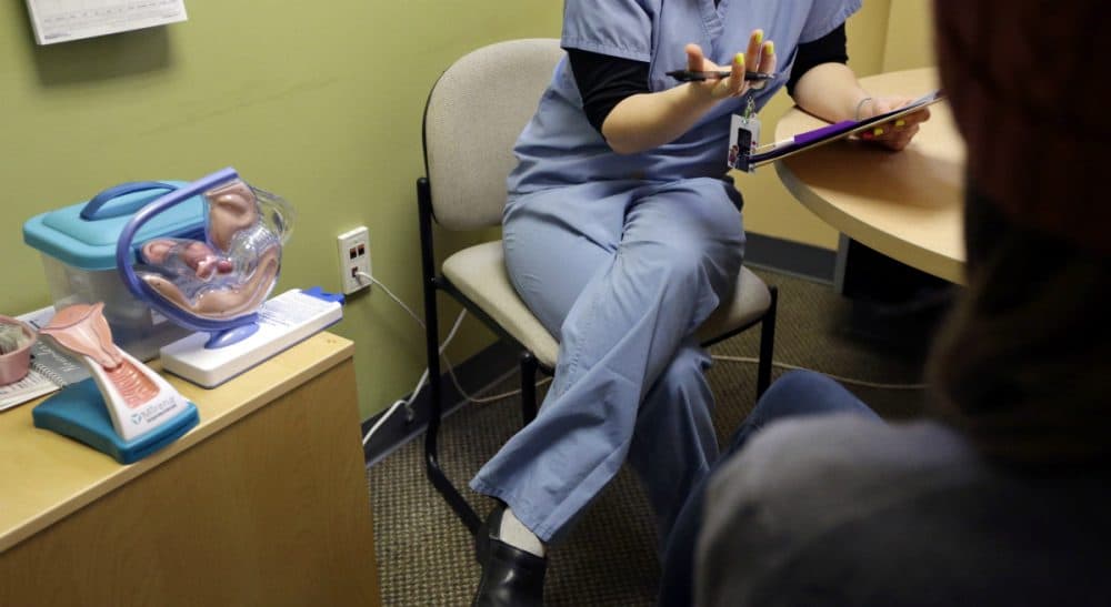 Anti-abortion activists are harrying the wrong enemy, says Rich Barlow. The law, not Planned Parenthood, should be the focus. In this Dec. 17, 2013, photo, an unidentified medical clinician interviews a patient at a Planned Parenthood location in Boston. (Steven Senne/ AP)