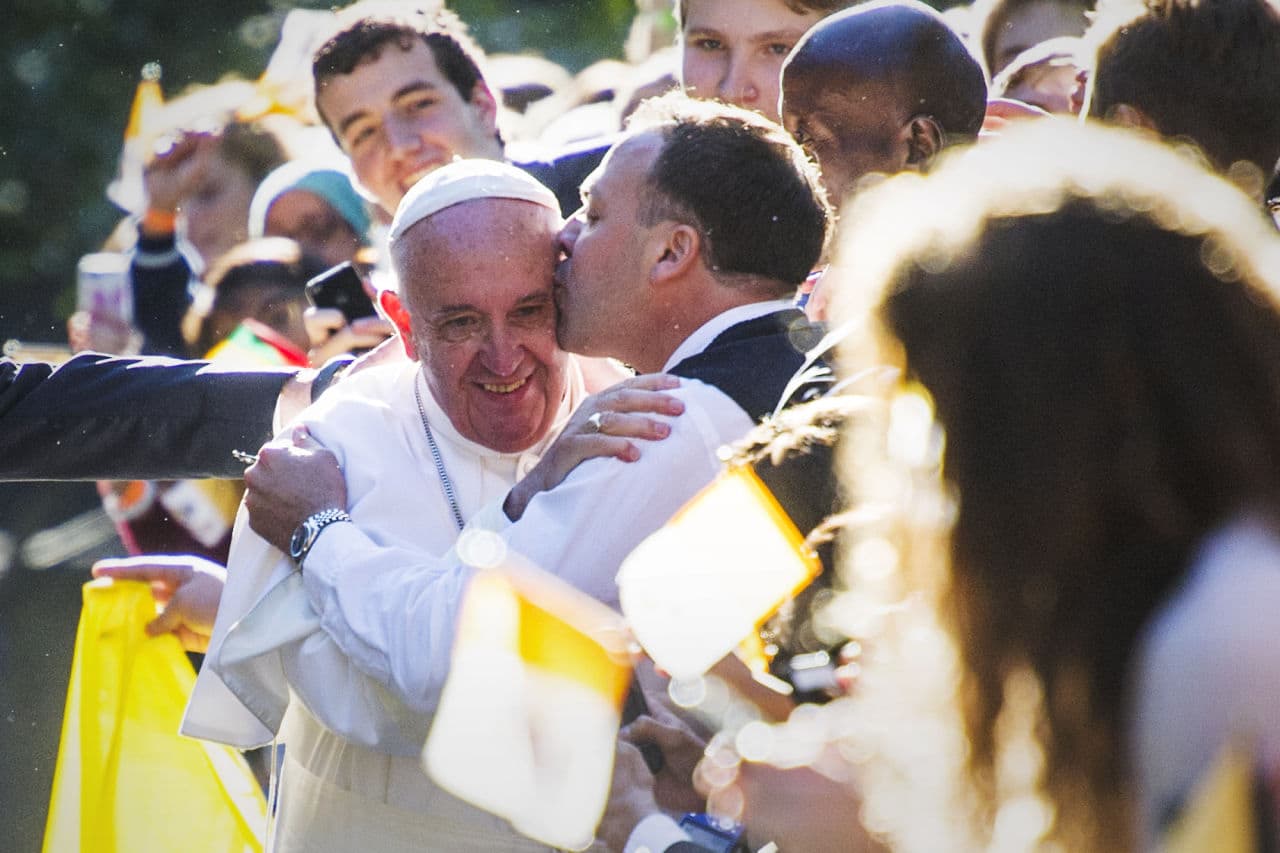 Pope Francis is kissed by a well-wisher as he departs the Apostolic Nunciature. (Cliff Owen/AP)