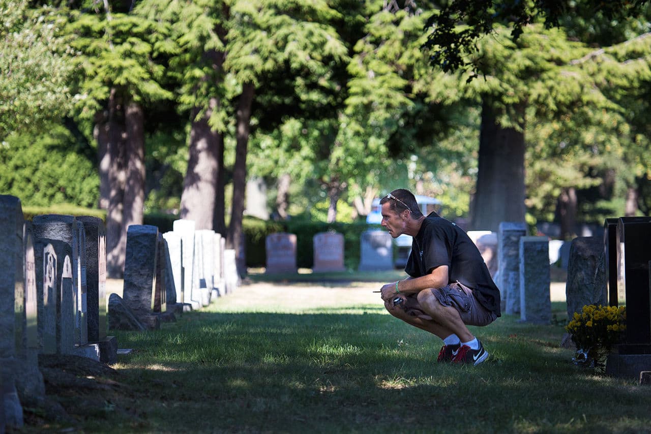 Joey visits his parents grave at Woodlawn Cemetery in Everett. His mother died earlier this year, the same day Joey got out of jail for the fourth time. "I miss her terribly," he says. (Jesse Costa/WBUR)