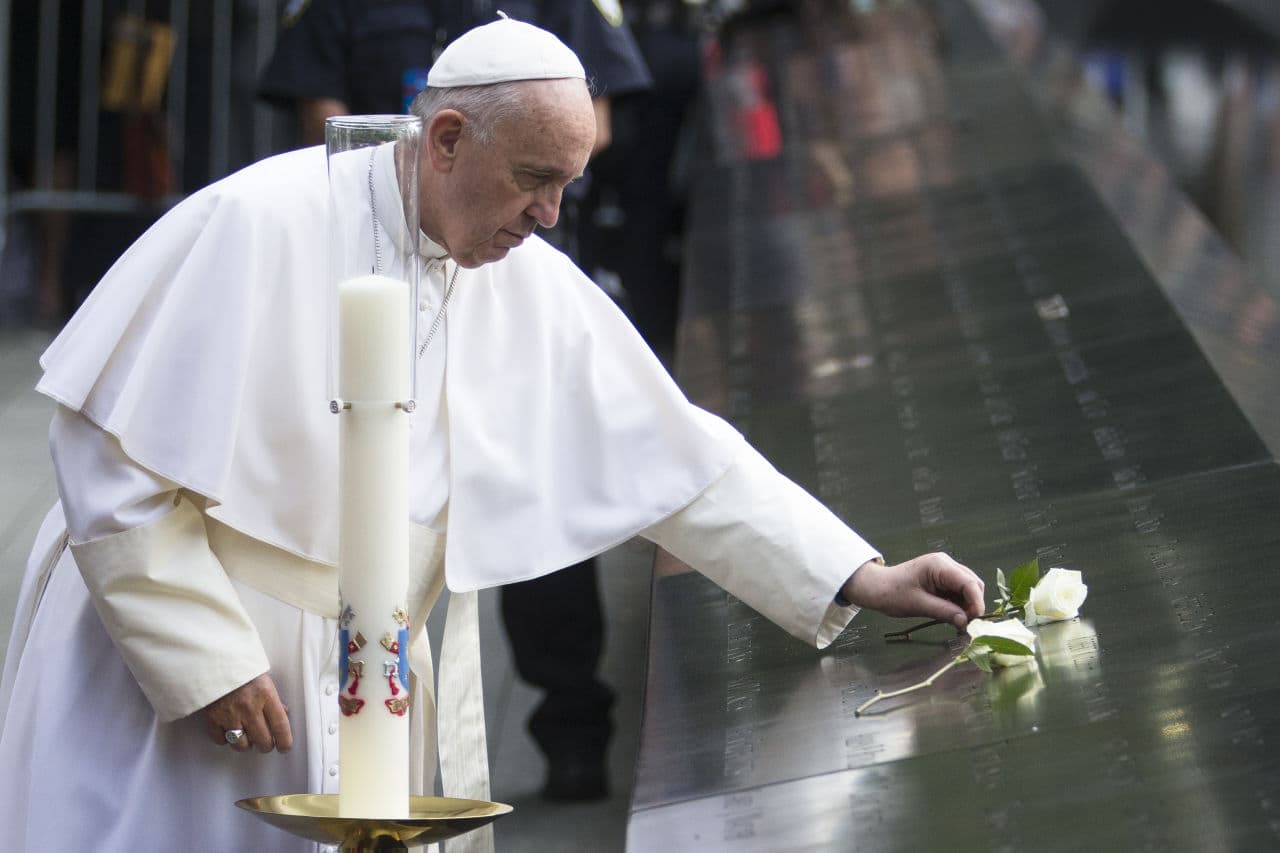 Pope Francis places a white rose at the South Pool of the 9/11 Memorial in downtown Manhattan, Friday, Sept. 25, 2015, in New York. (John Minchillo/AP)