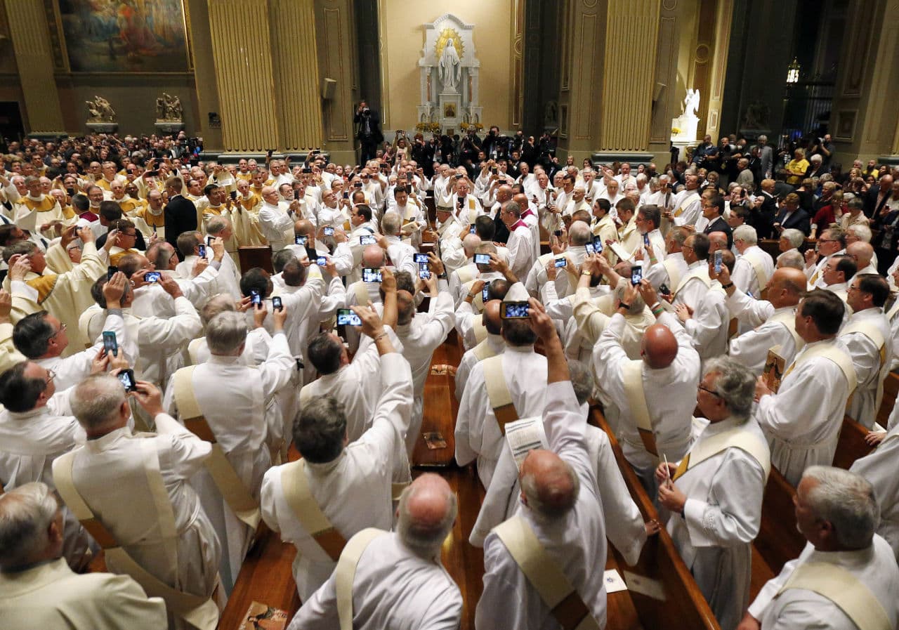 Pope Francis, center, processes toward the altar at Cathedral Basilica of Sts. Peter and Paul to start a mass, Saturday, Sept. 26, 2015, in Philadelphia. (Julio Cortez/AP)