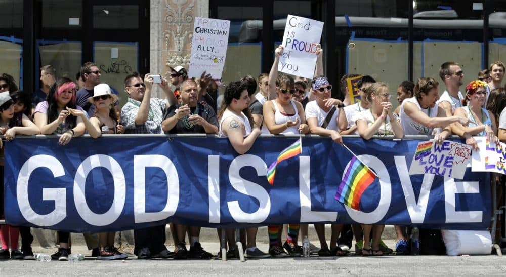 On this Bisexual Awareness Day, considering the role that faith communities can -- and should -- play in welcoming believers of all sexualities. Pictured: People stand behind a banner during the annual Chicago Pride Parade on Sunday, June 28, 2015, in Chicago. (Nam Y. Huh/AP)