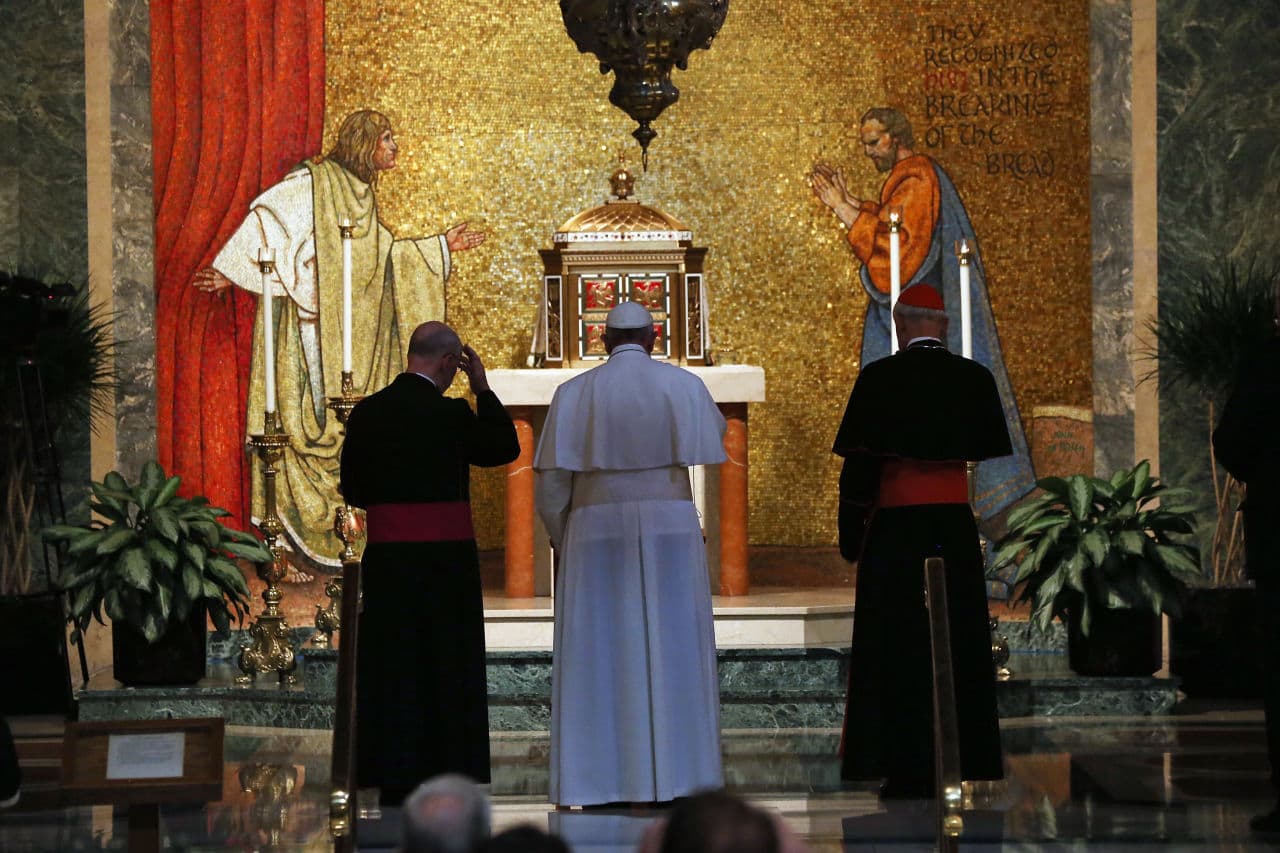 Pope Francis stands at the alter of the Blessed Sacrament Chapel for a private prayer before participating in a midday prayer service at the Cathedral of St. Matthew in Washington. (Mark Wilson/AP)