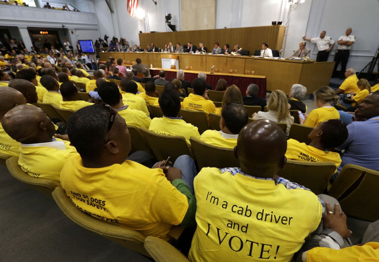 Taxi drivers sit during a hearing Tuesday at the State House on the regulation of ride-hailing companies such as Uber and Lyft. (Steven Senne/AP)
