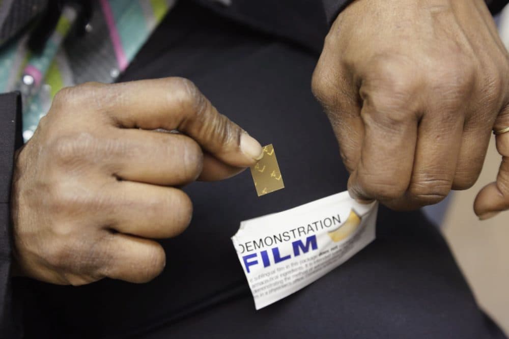 In this 2013 file photo, a recovering heroin addict holds a demonstration dose of the medication Suboxone. (M. Spencer Green/AP)