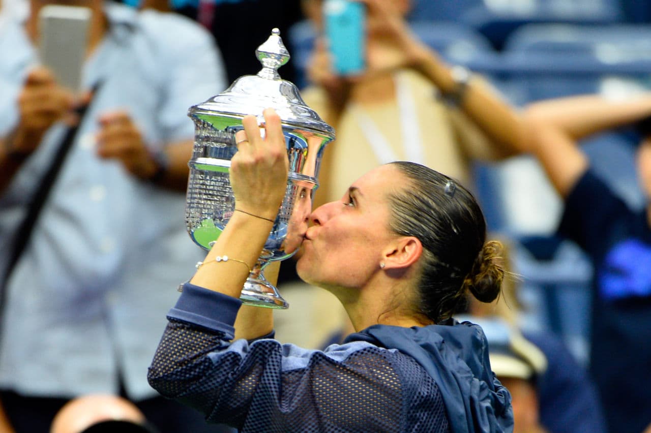 Flavia Pennetta of Italy kissed the winner's trophy after defeating Roberta Vinci in the Women's Singles Final.  It was Pennetta's first career grand slam title.  She announced her retirement shortly after the match.(Alex Goodlett/ Getty Images)