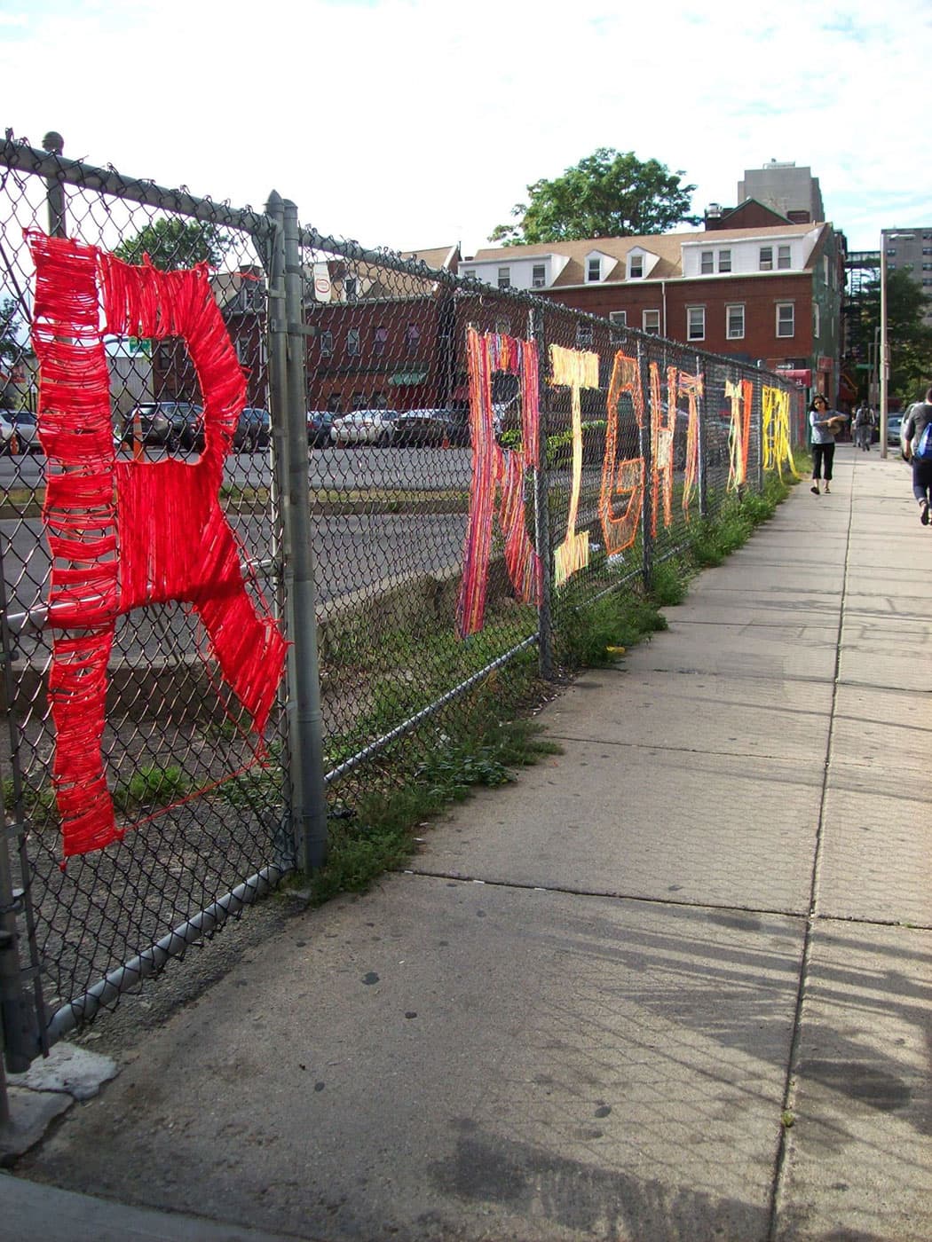 Yarn-bombing spells out "R Right to Remain" along a fence at 56 Tyler St., Boston. (Courtesy)