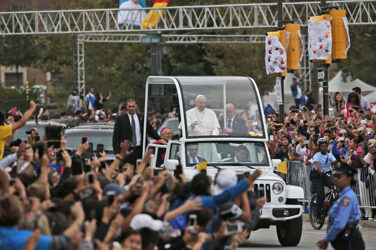 Pope Francis waves to the crowd from the popemobile during Sunday&#039;s parade in Philadelphia. (Alex Brandon/AP)