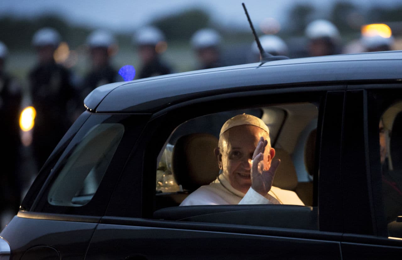 Pope Francis waves from his Fiat as he prepares to depart for Rome at Philadelphia International Airport in Philadelphia on Sunday. (Laurence Kesterson/AP)