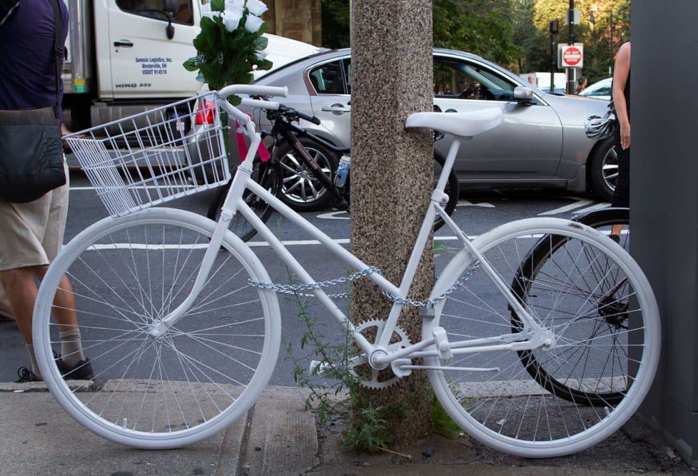 Anita Kurmann's ghost bike is fastened to a street sign at the Back Bay intersection where she died. (Hadley Green for WBUR)