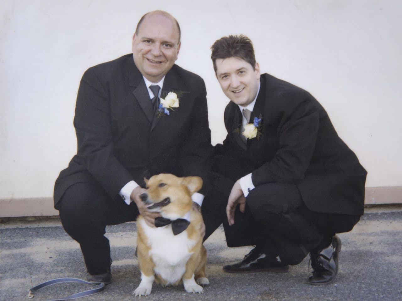Marlin Collingwood, left, and Gary Girton kneel with one of their corgis. The Medford couple had married on a beach in Provincetown less than two years after same-sex marriage was legalized in Massachusetts. (Courtesy Marlin Collingwood)