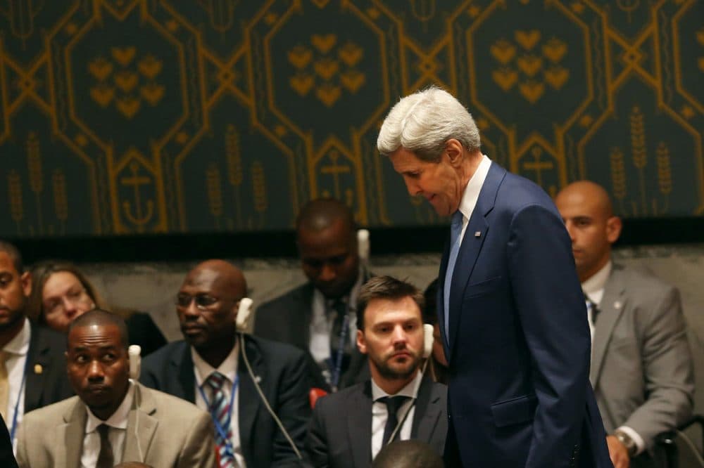 Secretary of State John Kerry entering a United Nations meeting in New York, as delegates listen to interpreters through earpieces. (Spencer Platt/Getty Images)