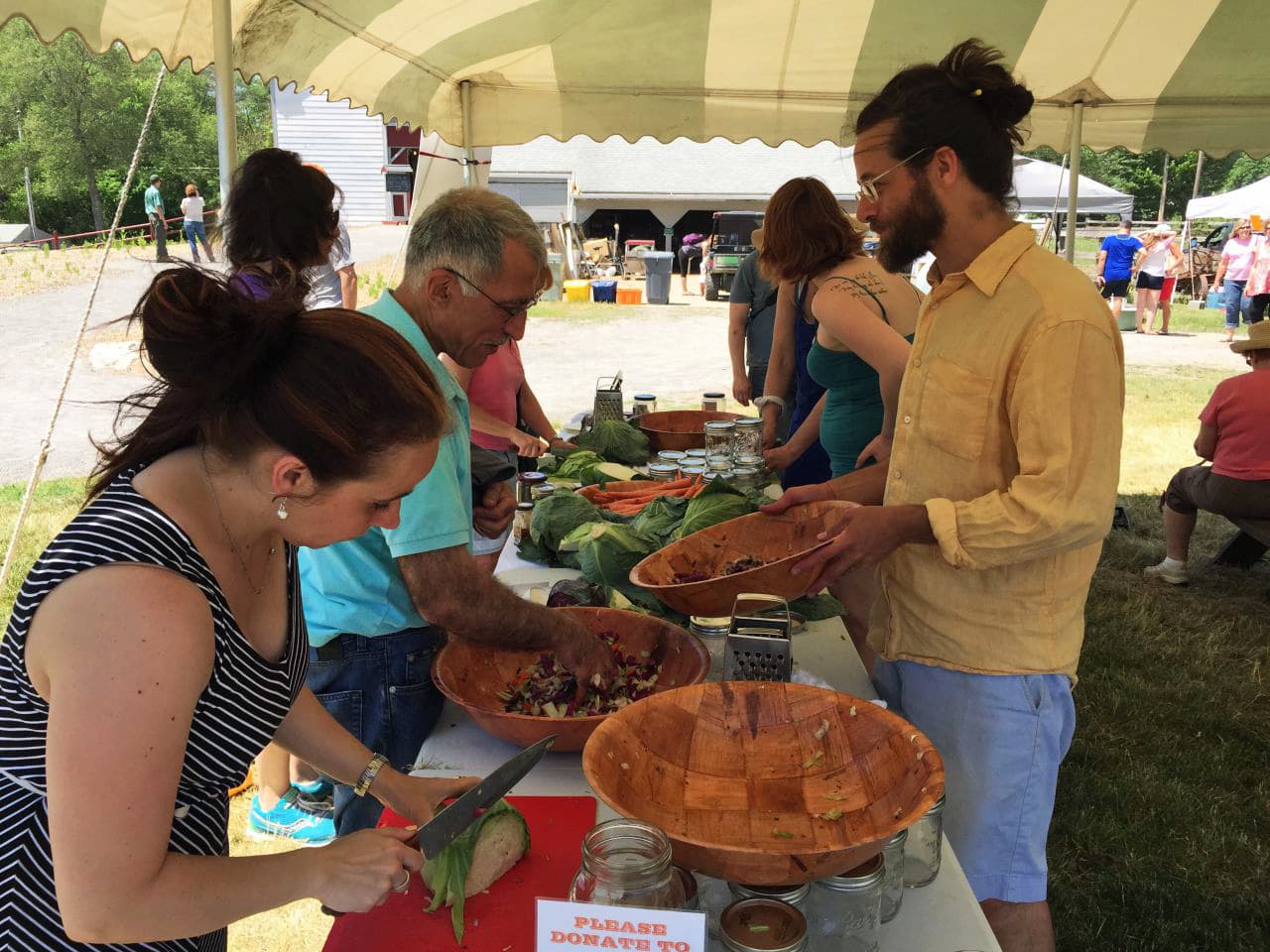 Jeremy Ogusky (right) at a kraut mob, or a sauerkraut-making event, at Powisset Farm in Dover. (Andrea Shea/WBUR)