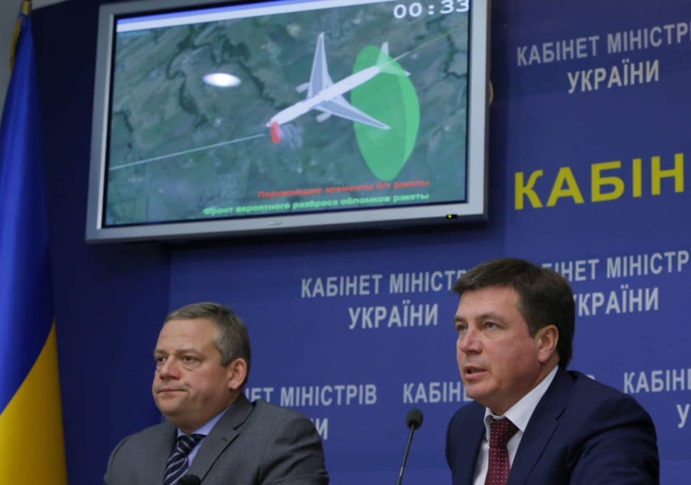 Vice Prime Minister and chairman of the government commission to investigate the causes of the MH17 crash Hennadiy Zubko, right, speaks at a briefing for journalists in Kiev, Ukraine, Tuesday, Oct. 13, 2015. Investigators said the Buk missile that downed Malaysia Airlines Flight 17 exploded less than a meter from the cockpit, killing the two pilots and the purser inside in an instant and breaking off the front of the plane. The tragedy that killed all 298 people aboard the plane on July 17, 2014, wouldn’t have happened if anyone had thought to close the airspace of eastern Ukraine to passenger planes as fighting raged below, the Dutch Safety Board said. (Sergei Chuzavkov/AP Photo)