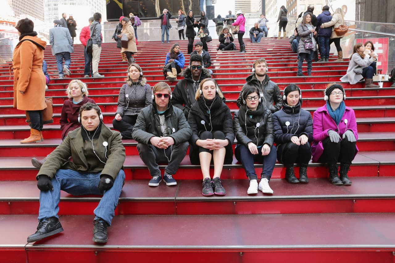 NYC commuters during a Meditation Moment in Times Square in celebration of the Westin Well-being Movement (partnered with Headspace) launch on March 20, 2014 in New York City. (Neilson Barnard/Getty Images for Westin Hotels & Resorts)