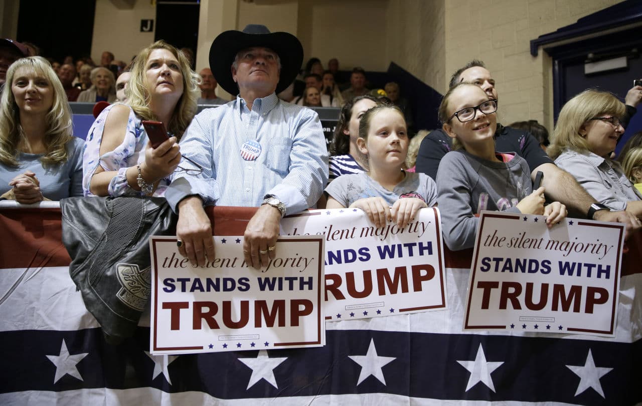 Audience members listen as Republican presidential candidate Donald Trump speaks during a campaign stop at the Burlington Memorial Auditorium, Wednesday in Burlington, Iowa. (Charlie Neibergall/AP)