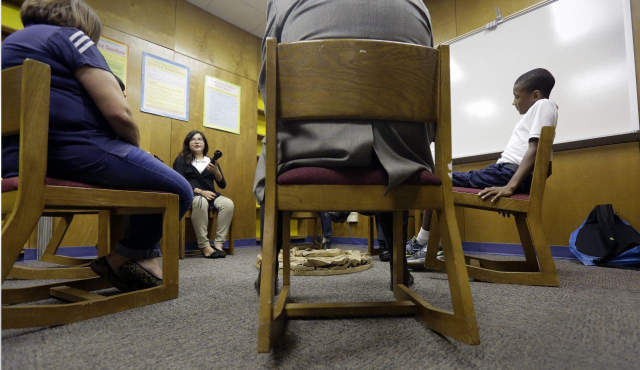 Two seventh graders discuss a recent conflict that they resolved through restorative justice, which included teachers and students gathering in circles for discussions, at Ed White Middle School, Friday, Oct. 16, 2015, in San Antonio. Philip Carney said that three years after starting a restorative discipline program as principal of Ed White Middle School in San Antonio, out-of-school suspensions have dropped by 72 percent. (Eric Gay/AP)