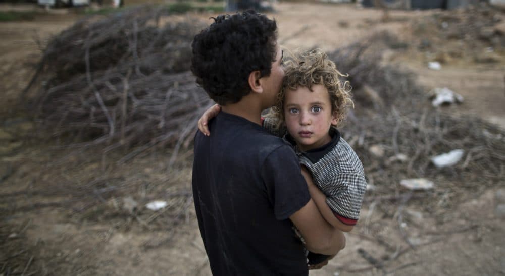 John Tirman: &quot;These American wars contain an element of Greek tragedy, beginning with hubris and ending with an unconscious, Oedipal urge to blind ourselves to the horror of what we’ve done.&quot; Pictured:
A Syrian refugee boy carries his younger brother back to their tent at an informal tented settlement near the Syrian border on the outskirts of Mafraq, Jordan, Tuesday, Aug. 4, 2015. (Muhammed Muheisen/AP)