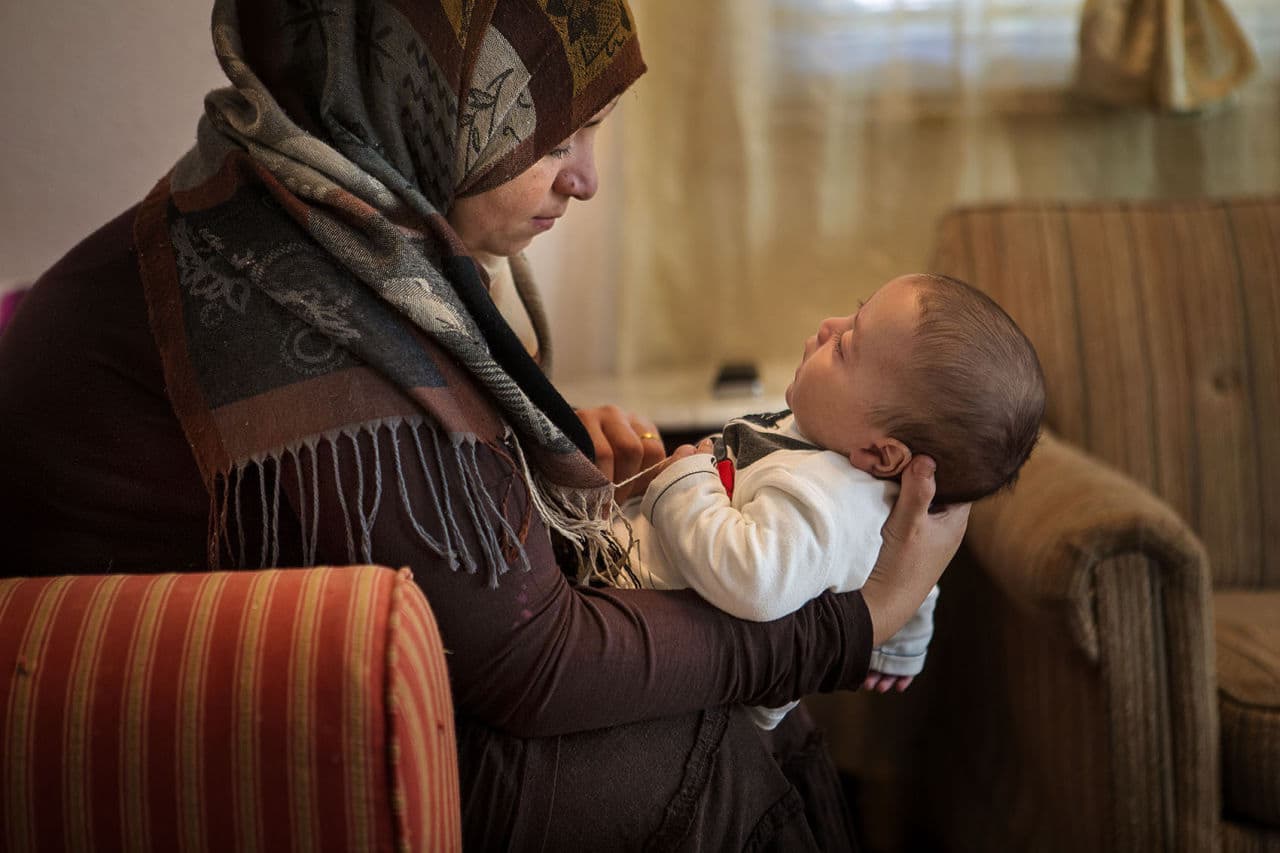 Zenab Al Nassar holds her 2-month-old baby boy, Saleh -- the first U.S. citizen among them. (Jesse Costa/WBUR)