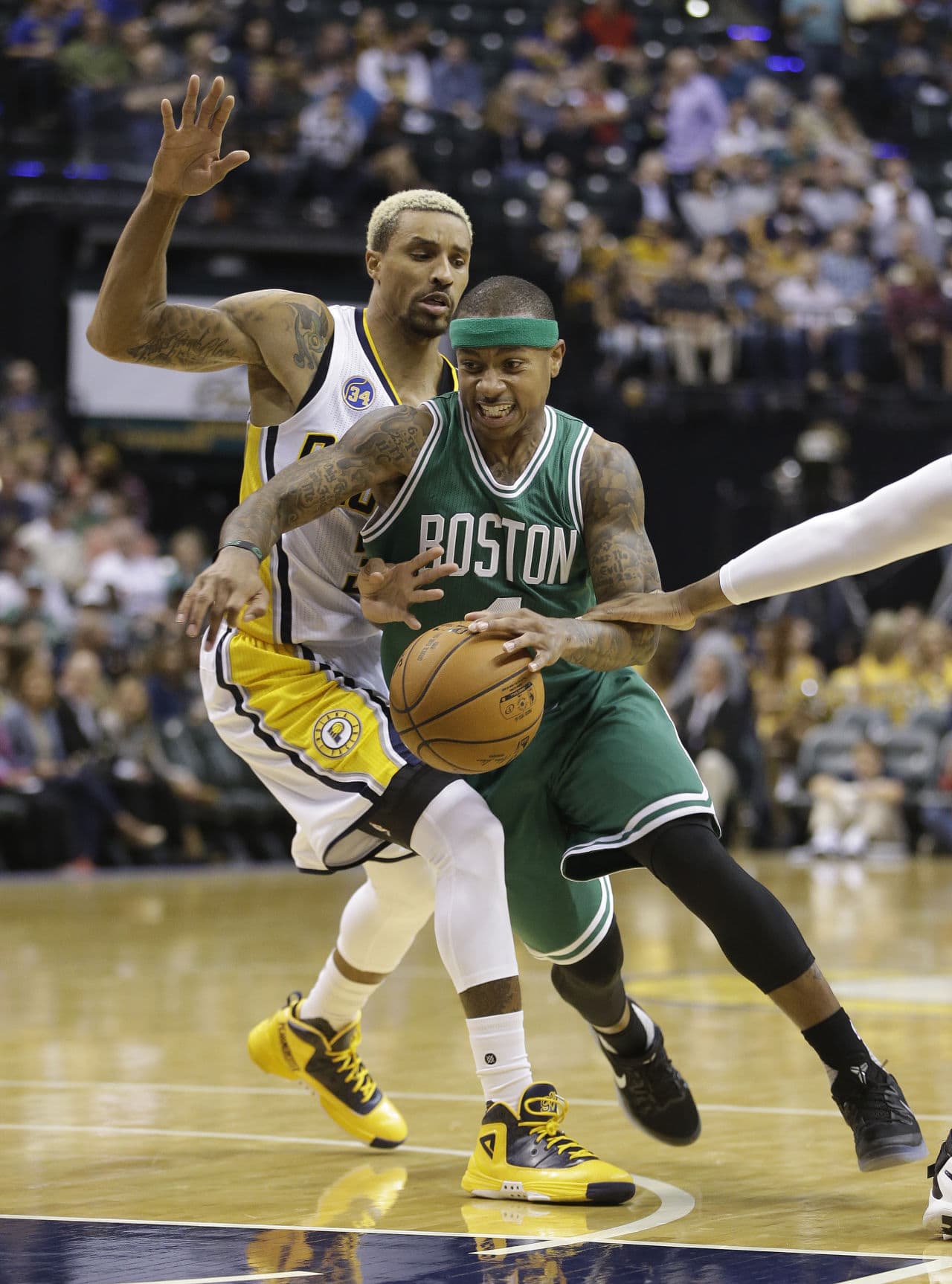 Boston Celtics' Isaiah Thomas (4) goes to the basket against Indiana Pacers' George Hill (3) during yesterday's game.  (Darron Cummings/AP)