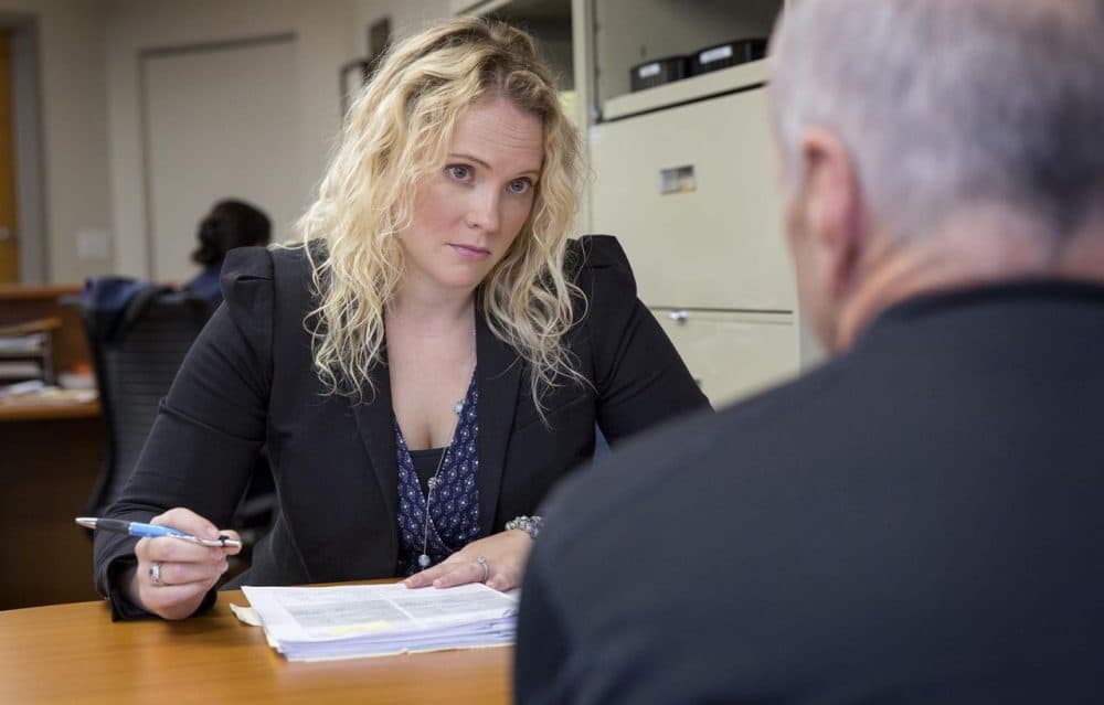 Eve Elliott, a staff attorney at Veterans Legal Services, talks with a veteran. (Robin Lubbock/WBUR)