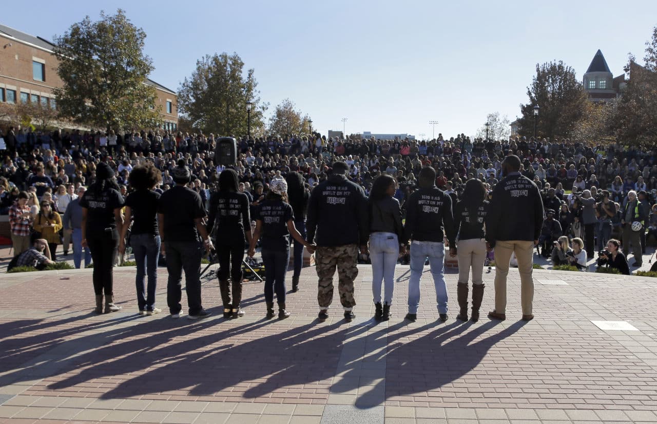 Members of black student protest group Concerned Student 1950 hold hands following the announcement that University of Missouri System President Tim Wolfe would resign Monday, Nov. 9, 2015, at the university in Columbia, Mo. Wolfe resigned Monday with the football team and others on campus in open revolt over his handling of racial tensions at the school. (Jeff Roberson/AP)