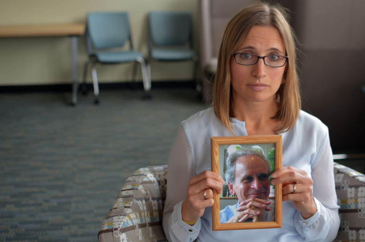 Emily Stein holds a photo of her late father, who was killed by a distracted driver. She told WBUR that her father's death has driven her to raise awareness about the dangers of distracted driving. (Sharon Brody/WBUR)