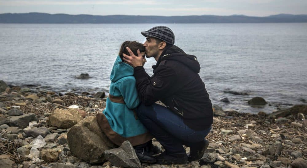 Eileen McNamara: &quot;If they are not the embodiment of the promise engraved on the Statue of Liberty, who exactly are the 'huddled masses yearning to breathe free' that Emma Lazarus described?&quot; In this photo, a Syrian man kisses his daughter shortly after disembarking from a dinghy at a beach on the Greek island of Lesbos, Monday, Nov. 16, 2015. (Santi Palacios/AP)