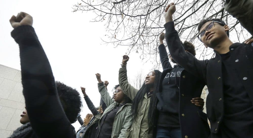 Students at Boston College raise their arms during a solidarity demonstration on the school's campus, Thursday, Nov. 12, 2015, in Newton, Mass. The protest was among numerous campus actions around the country following the racially charged strife at the University of Missouri. (Steven Senne/ AP)